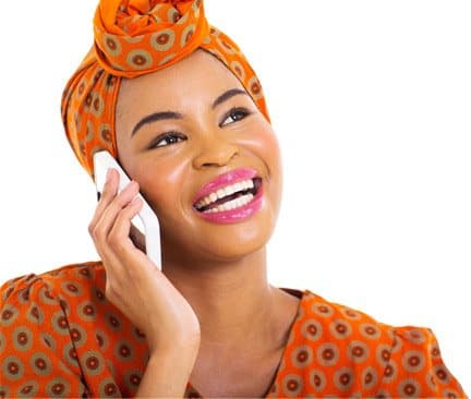 A woman smiling while talking on her phone (stock photo)