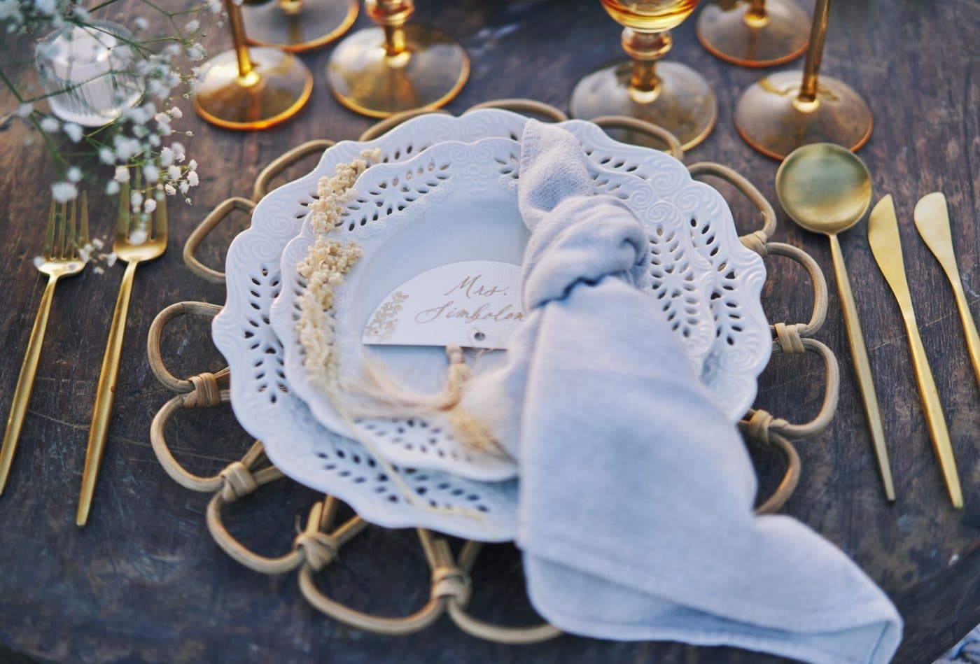 Gold cutlery and lace-edged plates